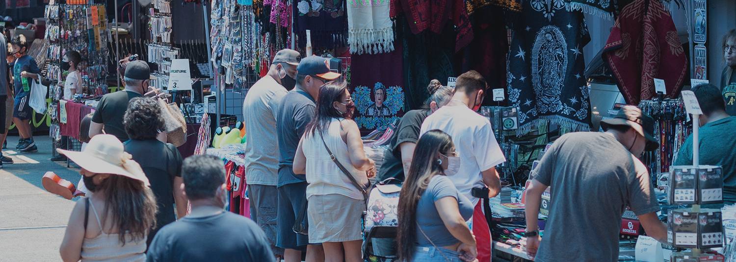 Crowds of people looking at outdoor vendor shops