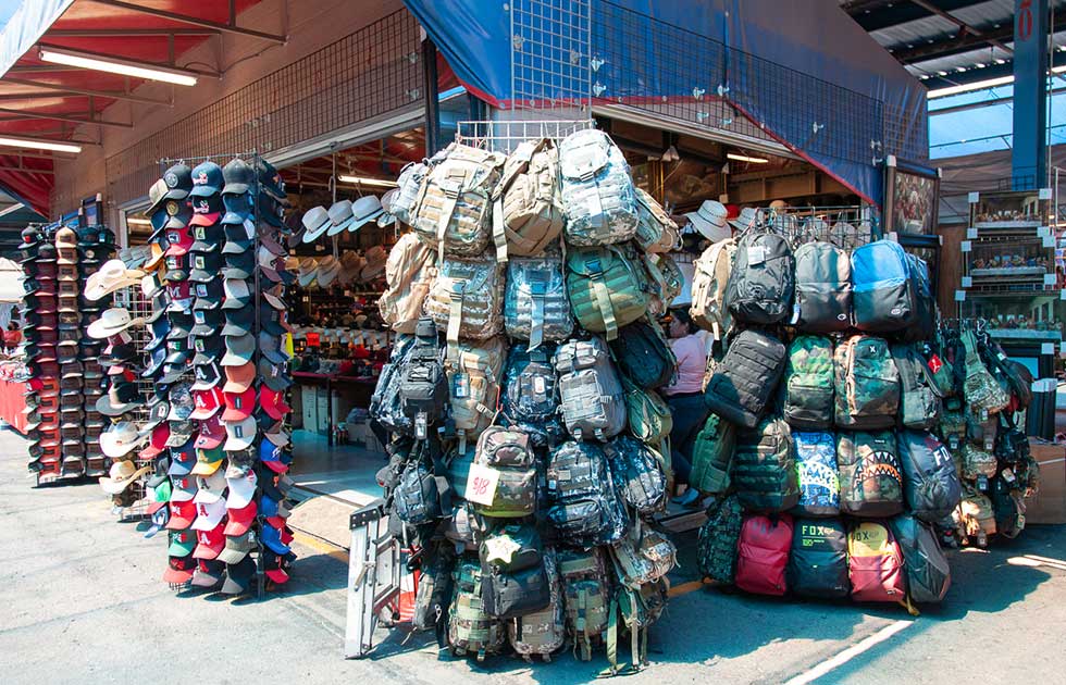 Outdoor Vendor selling backpacks and hats